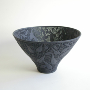 Sandra Black, bowl from the ‘Hardenbergia series’, slip cast Seeleys ebony porcelain, carved, pierced and polished, 26x15.4cm; Collection of the Art Gallery of South Australia. Photo: Victor France.Sandra Black, etched black porcelain bowl.